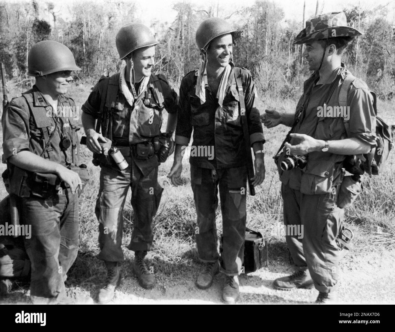 Associated Press photographer Eddie Adams, right, chats with ...