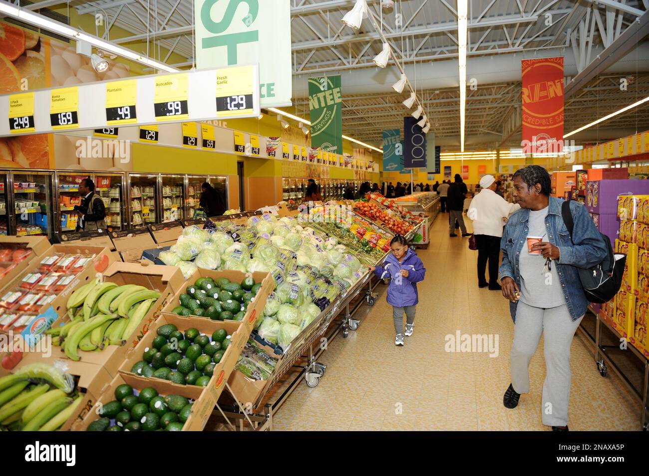 Attendees check out the produce section at the grand opening preview