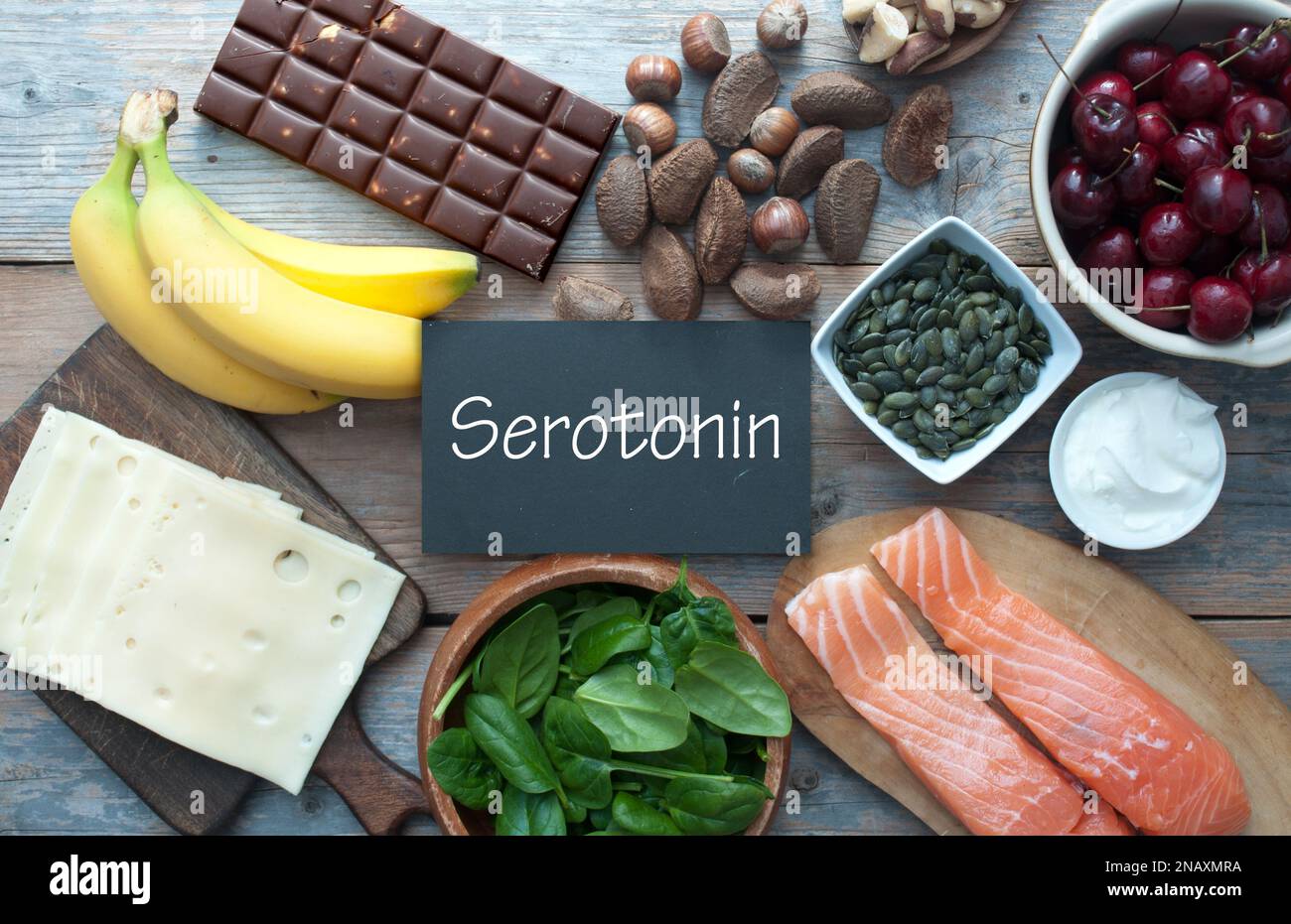 Serotonin, good mood food concept, inlcluding brazil nuts, dark chocolate, cherries and salmon Stock Photo