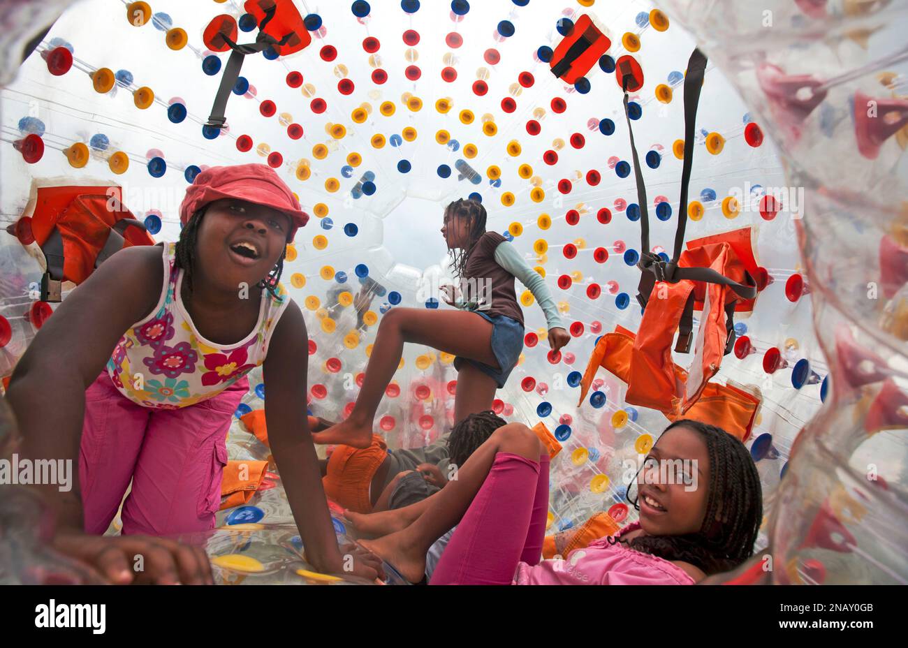 Kenyan girls tumble inside a giant inflatable rolling ball located in