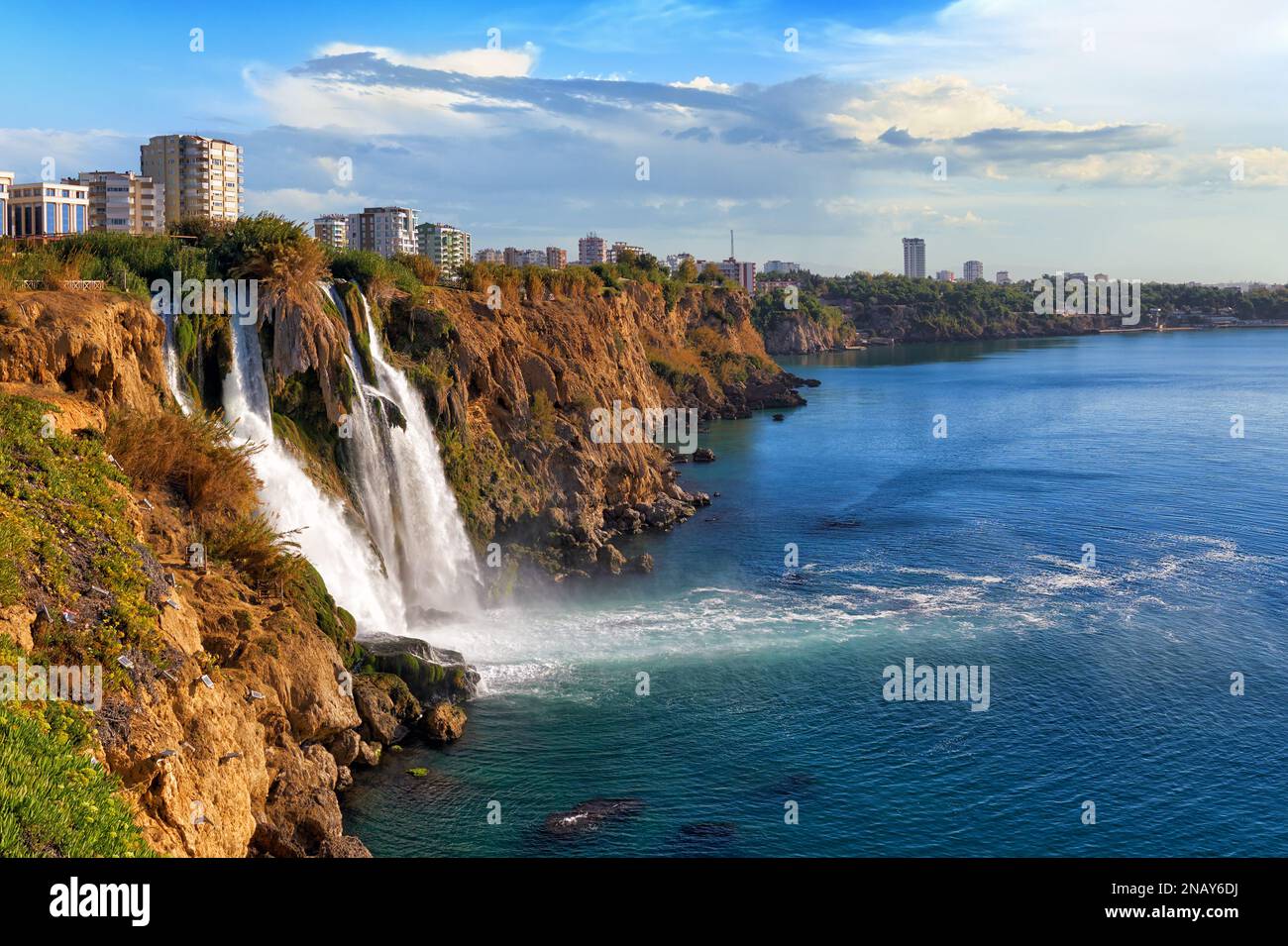 Picturesque landscape of the Lower Duden waterfall against the backdrop of the steep shores of the Mediterranean Sea and urban development in the Anta Stock Photo