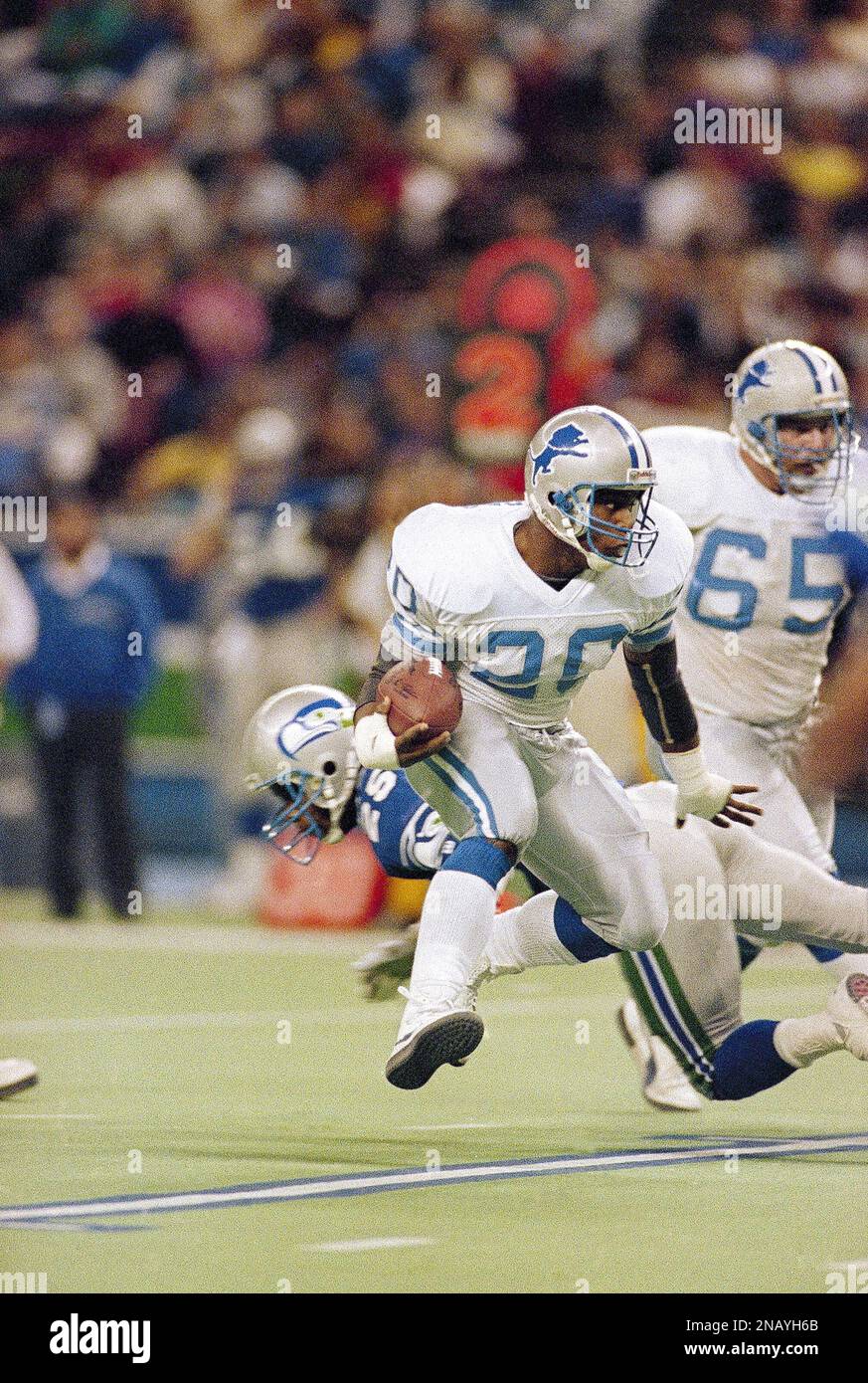 Barry Sanders (20) of the Detroit Lions makes his break up the field after  passing Robert Blackmon (25) of the Seattle Seahawks during their NFL game  in Seattle on Dec. 30, 1990.