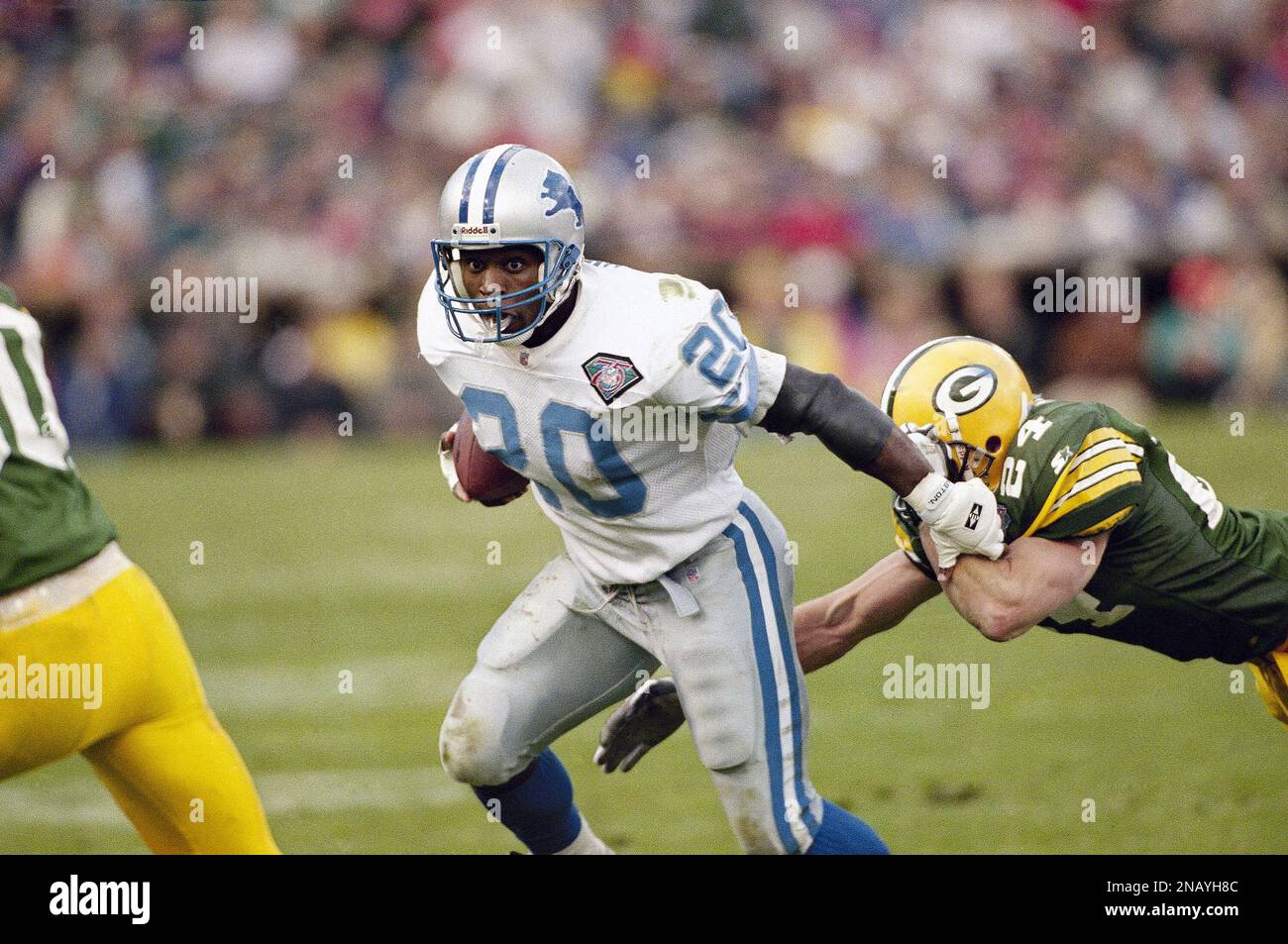 Detroit Lions' Barry Sanders evades a tackle by Green Bay Packers' Tim  Hauck as he runs with the ball during the second half in Milwaukee on Nov.  6, 1994. Sanders was held