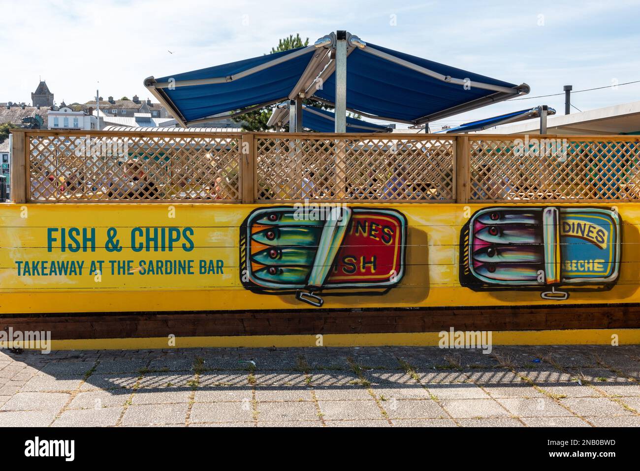 People sit in the sunshine eating out at the Rockfish Sardine Bar