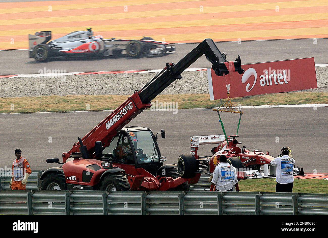 The car of Ferrari driver Fernando Alonso of Spain is lift up after he ...