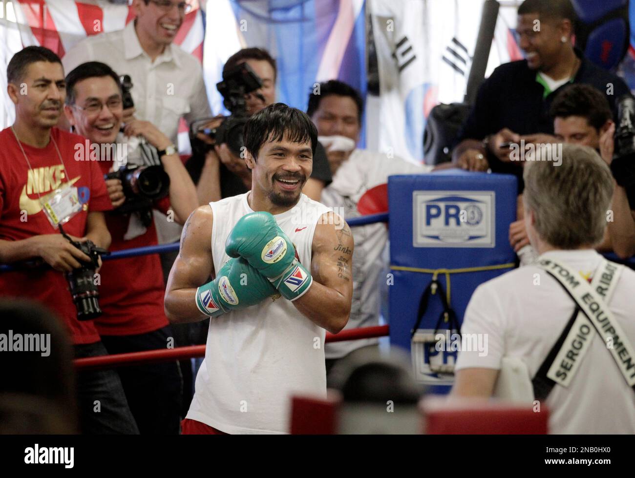 Boxer Manny Pacquiao, center, of the Philippines, works with his trainer Freddie Roach at the Wild Card Boxing Club in Los Angeles, Wednesday, Oct