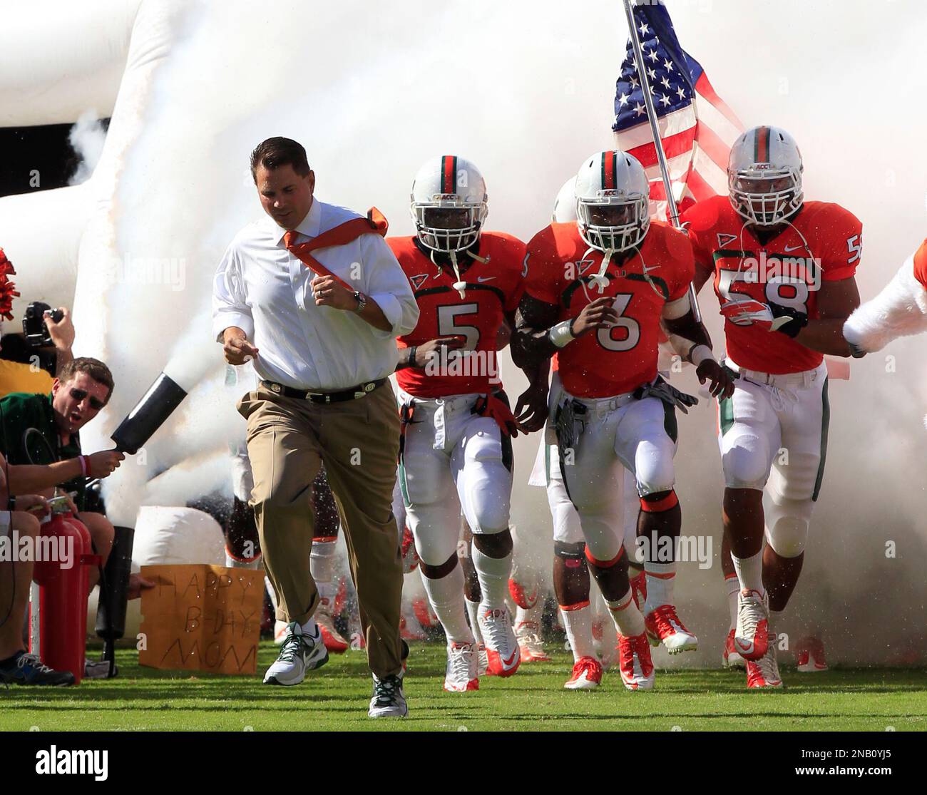 Miami Hurricanes' head coach Al Golden, left, leads the team during