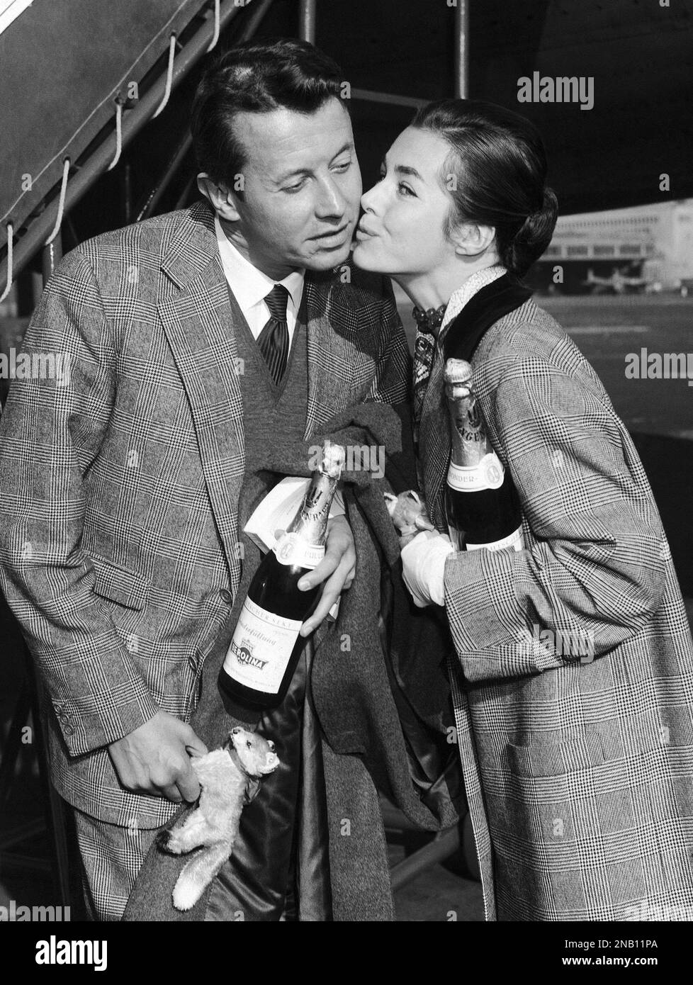 French actor Michel Auclair is greeted by German actress Marianne Koch upon his arrival on October 2, 1957 at the Tempelhof airport in Berlin, Germany picture