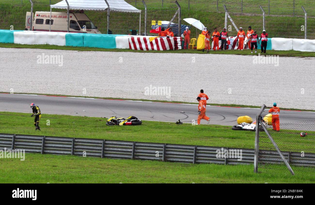 Colin Edwards of the US, left, reacts after a crash involving Italy's ...
