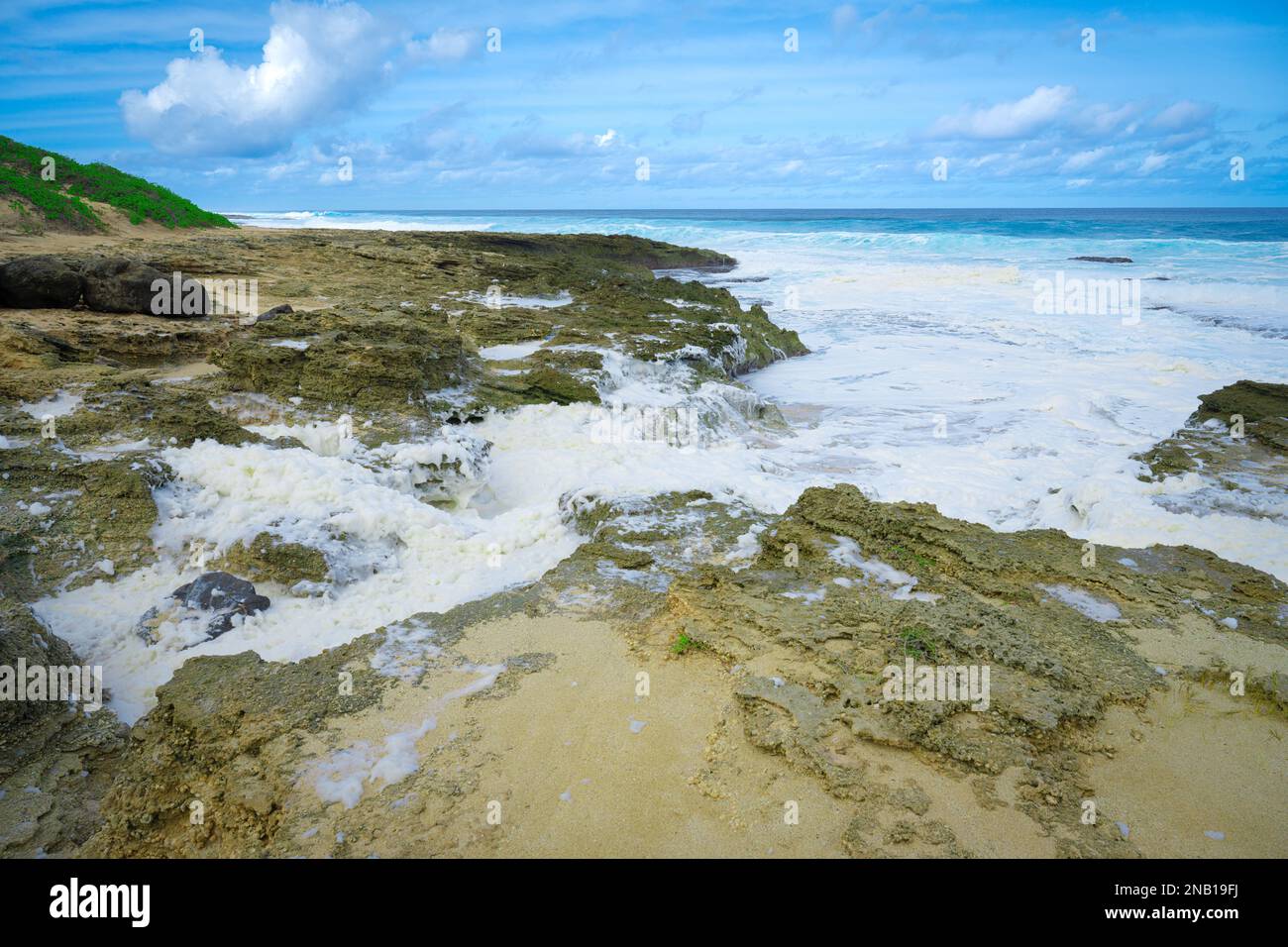 The foamy sea waves splashing onto the rocky coastline Stock Photo - Alamy