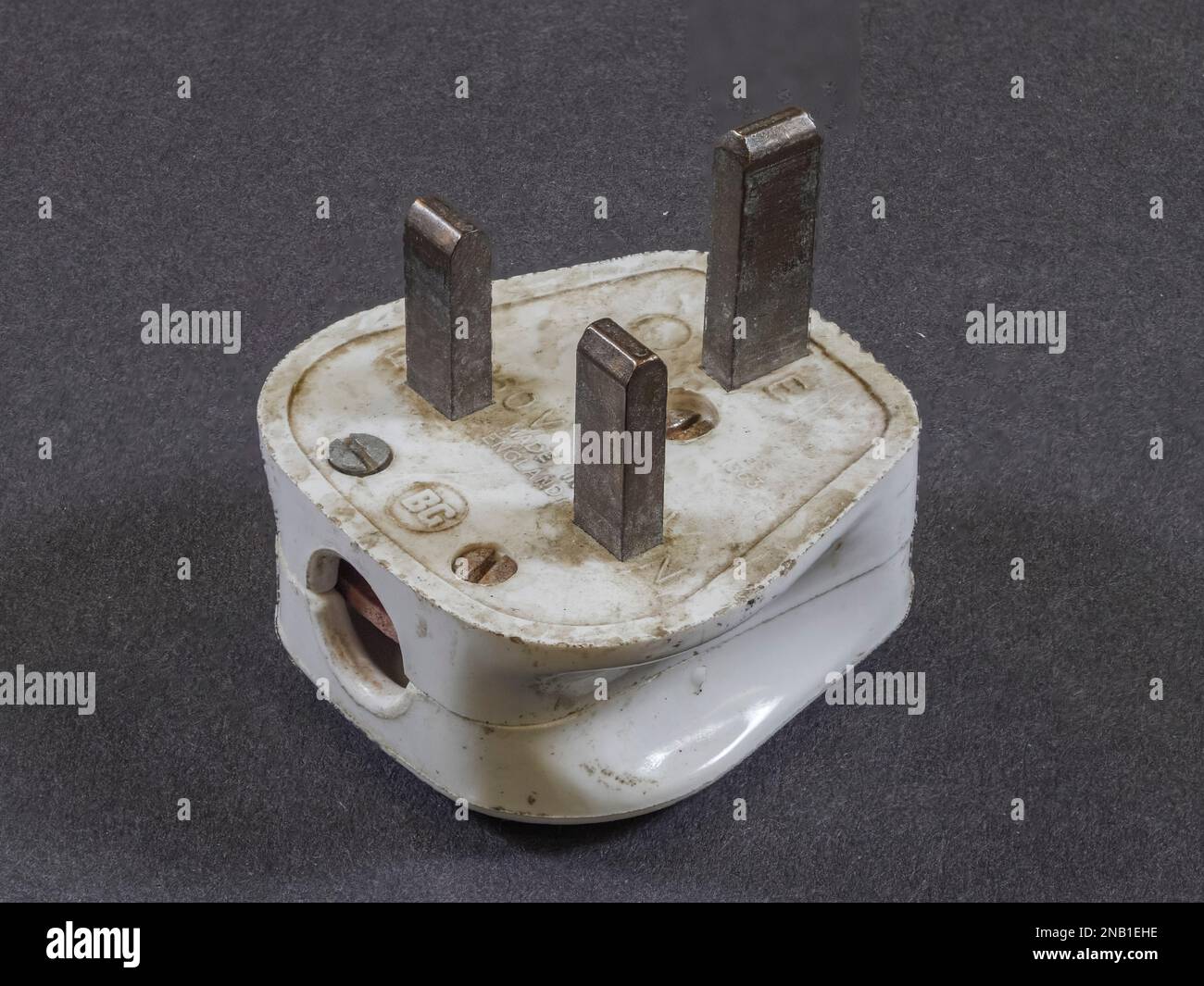 Example of a pre-1984 British 3 pin mains plug (after 1984, insulating sleeves were required on the live and neutral pins). Stock Photo