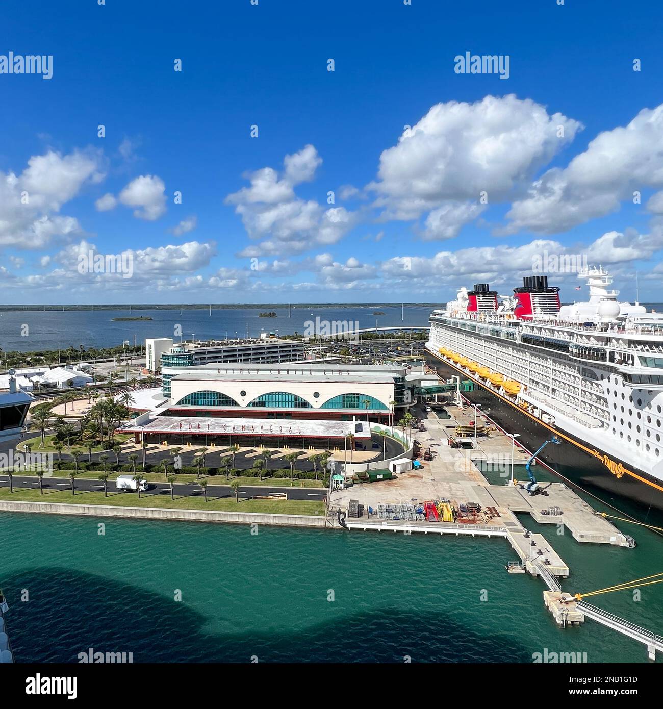 Orlando, FL USA - January 8, 2022:  The Disney Cruise line building and cruise ship Fantasy at dock in Port Canaveral, Florida. Stock Photo