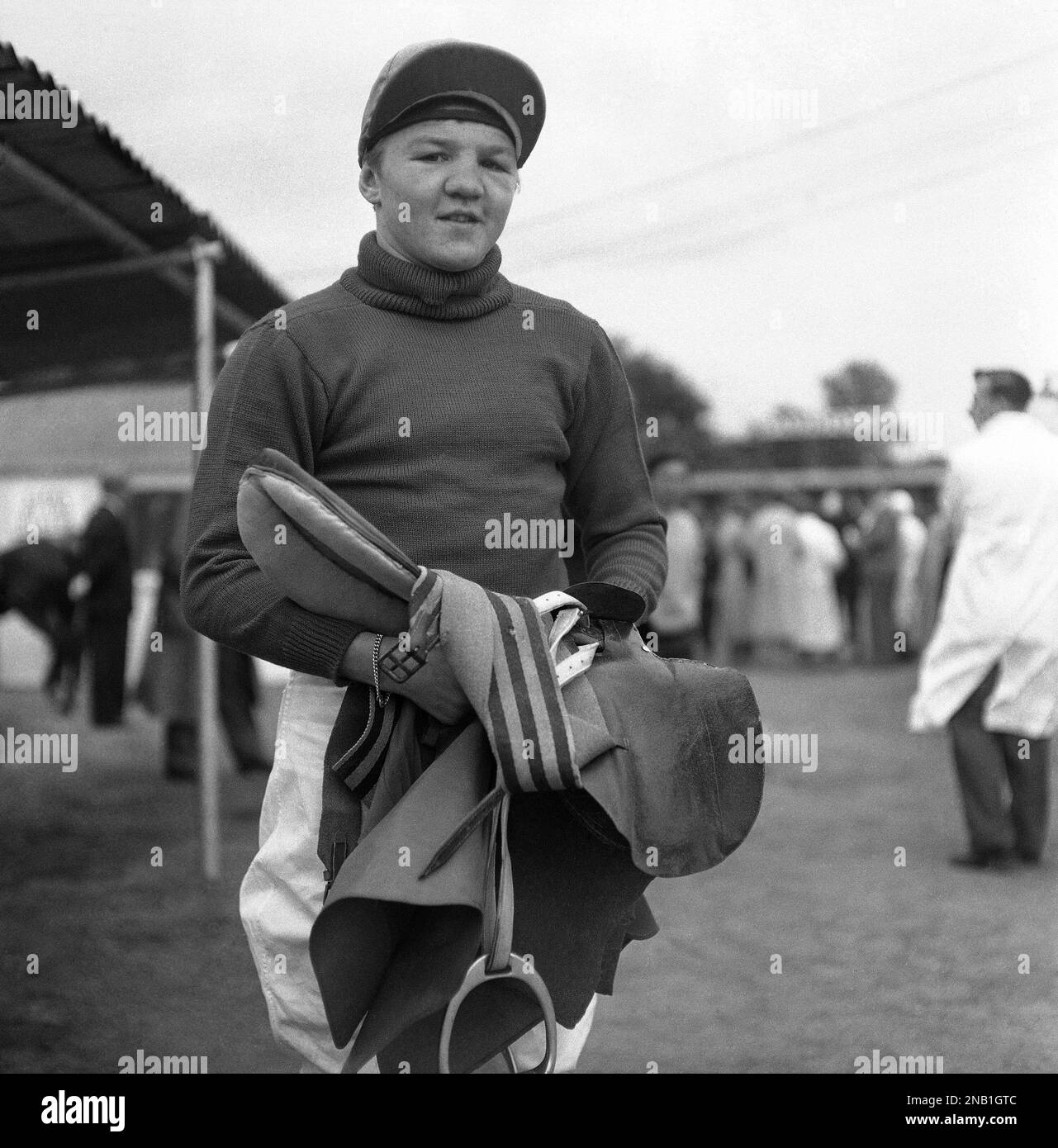 Britain’s exfeatherweight boxing champion Terry Spinks carries his