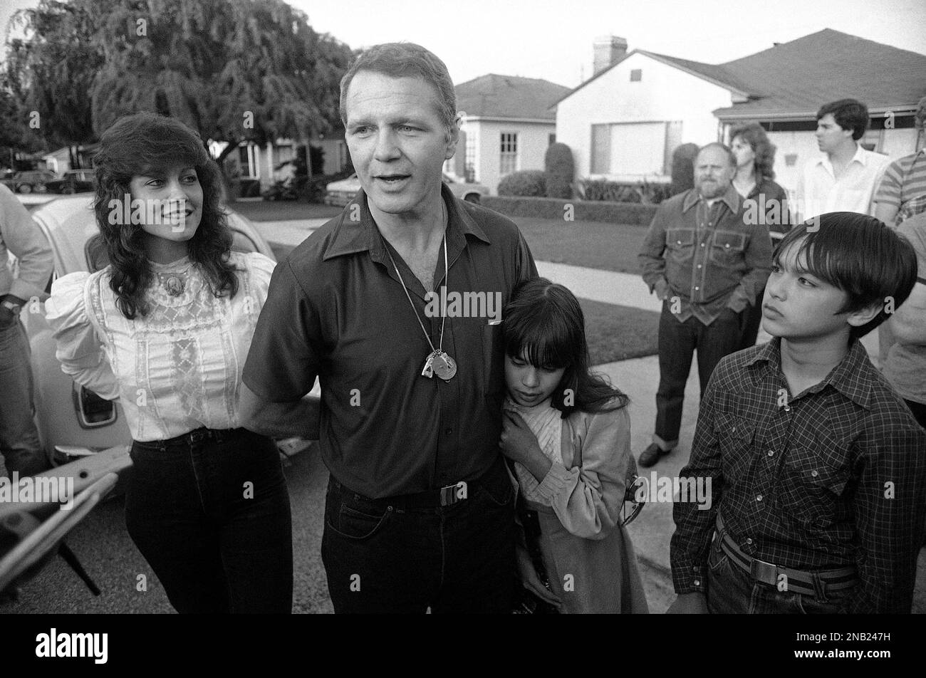 Former Green Beret officer James “Bo” Gritz talks to reporters as his wife  Claudia looks on and their daughter Melody hugs her father outside their  Westchester, California on March 13, 1983, home