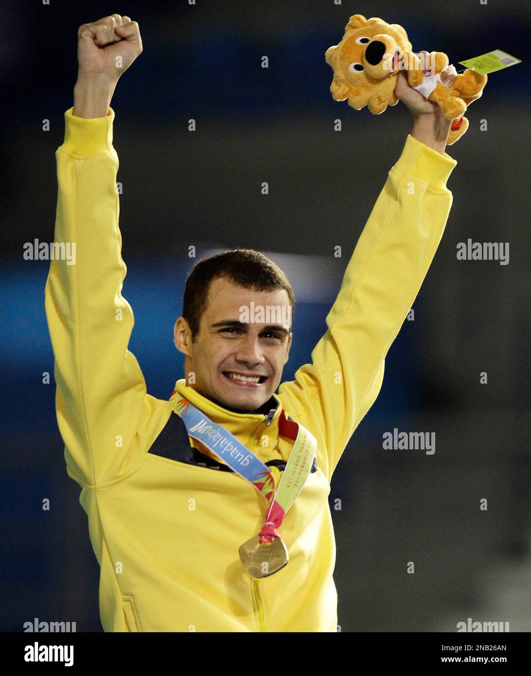 Brazil's Leonardo De Deus reacts after being awarded the gold medal for winning the men's 200m butterfly at the Pan American Games in Guadalajara, Mexico, Monday, Oct. 17, 2011. De Deus was initially disqualified, because of the sponsor’s logo on his swim cap according to Brazilian officials , and then reinstated as the gold medalist after an appeal. (AP Photo/Julie Jacobson) Stock Photo
