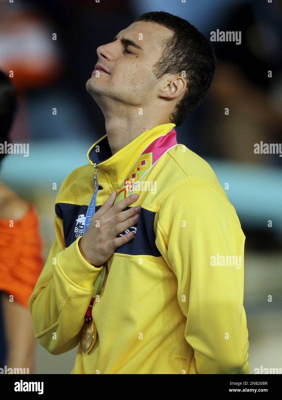 Brazil's Leonardo De Deus celebrates at the podium after winning the gold medal for the men's 200m backstroke at the Pan American Games in Guadalajara, Mexico, Monday, Oct. 17, 2011. De Deus was initially disqualified, according to Brazilian officials because of the sponsor’s logo on his swim cap, and then reinstated as the gold medalist after an appeal.(AP Photo/Silvia Izquierdo) Stock Photo