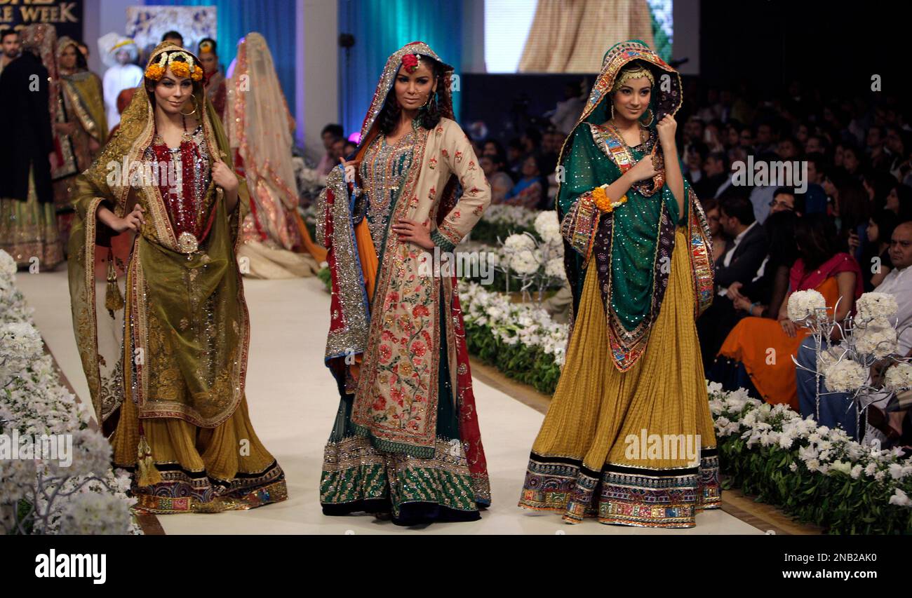 Models present creations of Pakistani designer Ali Xeeshan during a show of the Bridal Couture Week in Lahore Pakistan late night on Sunday Oct. 16 2011. AP Photo K.M. Chaudary Stock Photo Alamy