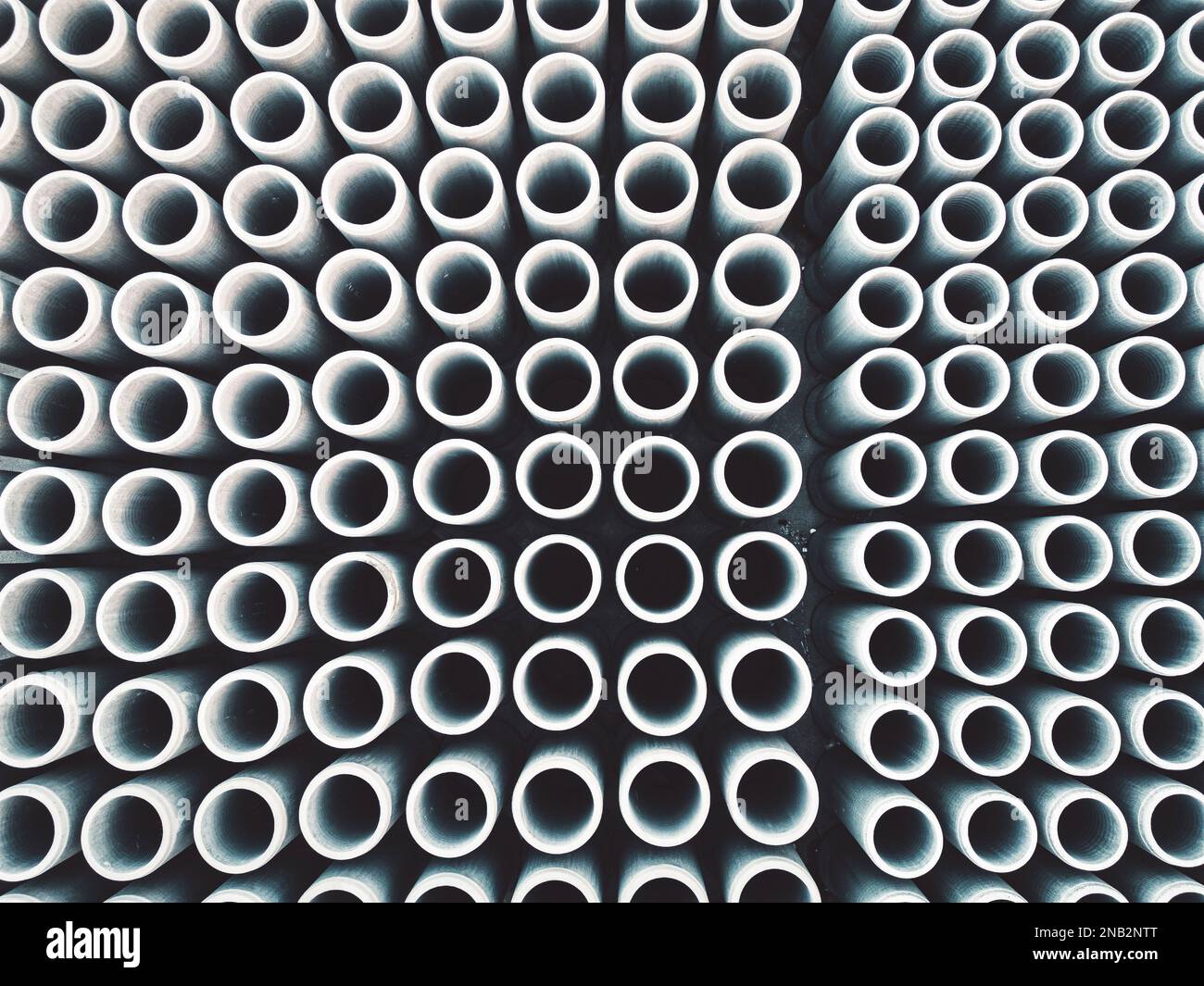 Top down view of round concrete pipes or pillars stacked in rows at the ...