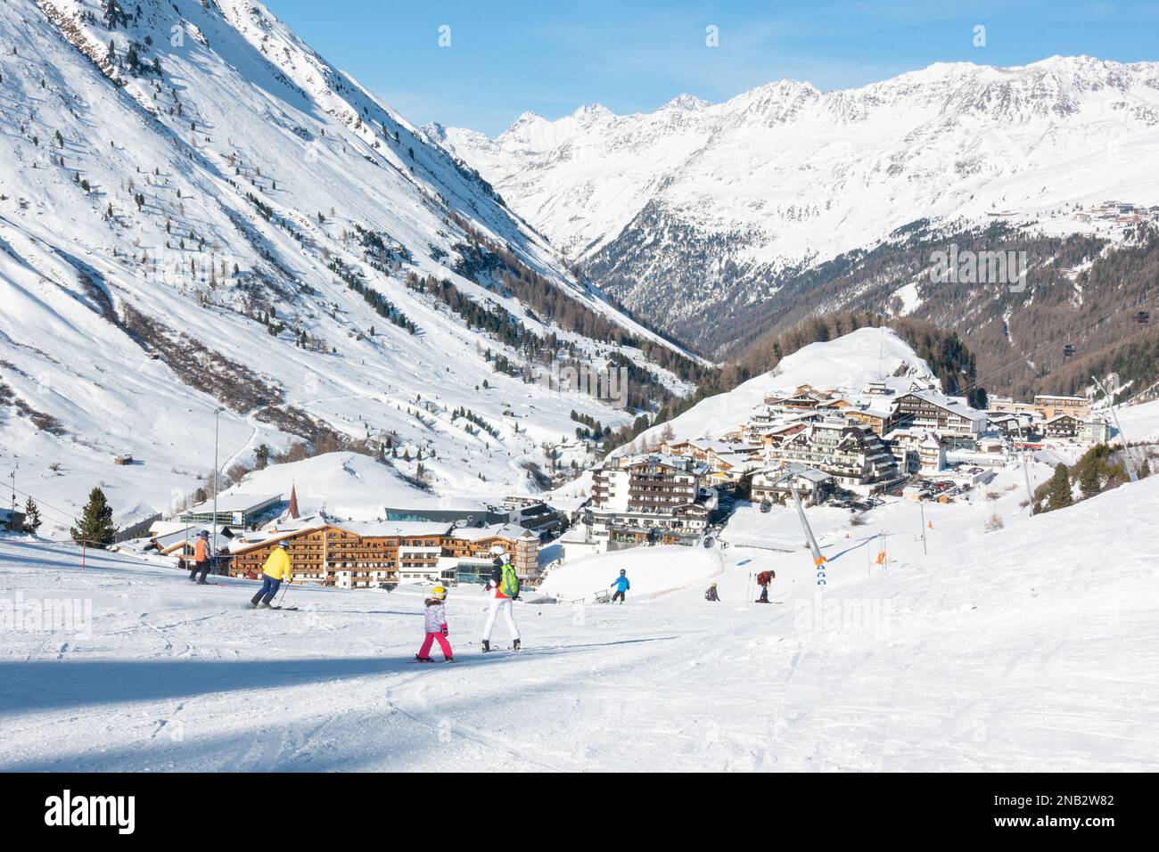 Obergurgl, Gurgl, Austria - skiers decending the slopes down to the village of Obergurgl Stock Photo