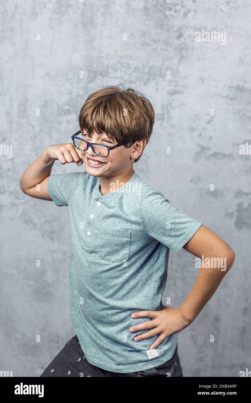a little boy with glasses making a silly face Stock Photo