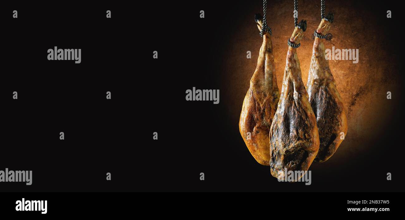 Slicing Spanish íberic ham. Spanish jamon and traditional food.Dry Spanish ham, Jamon Serrano, Bellota, Italian Prosciutto Crudo or Parma ham. Stock Photo