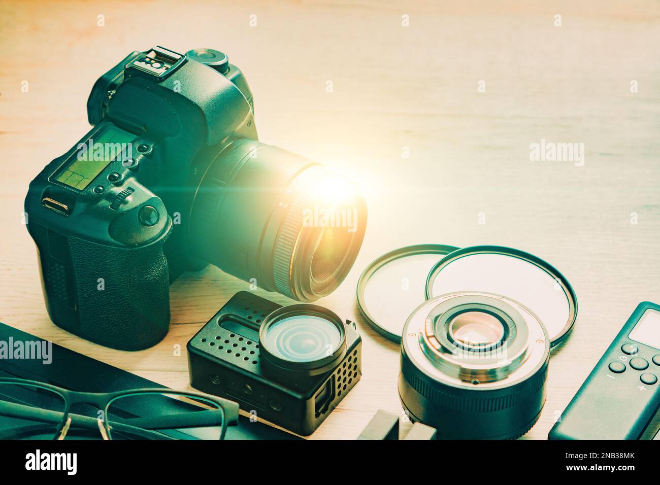 Digital photo workstation over black background.Top view of  digital camera, flash,lens and laptop.Professional Photographic Equipment. Stock Photo
