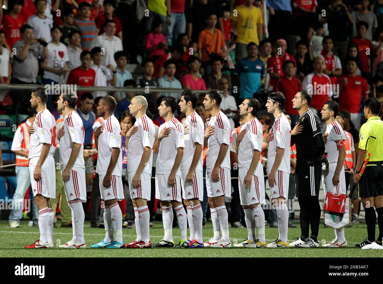 The Jordanian soccer team player sing their national anthem before