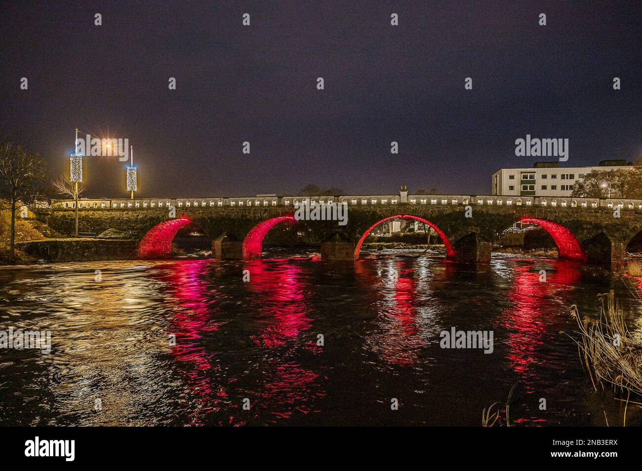 Tullbron at night, an old stone bridge crossing the river Atran in Falkenberg, Sweden, February 11, 2023 Stock Photo