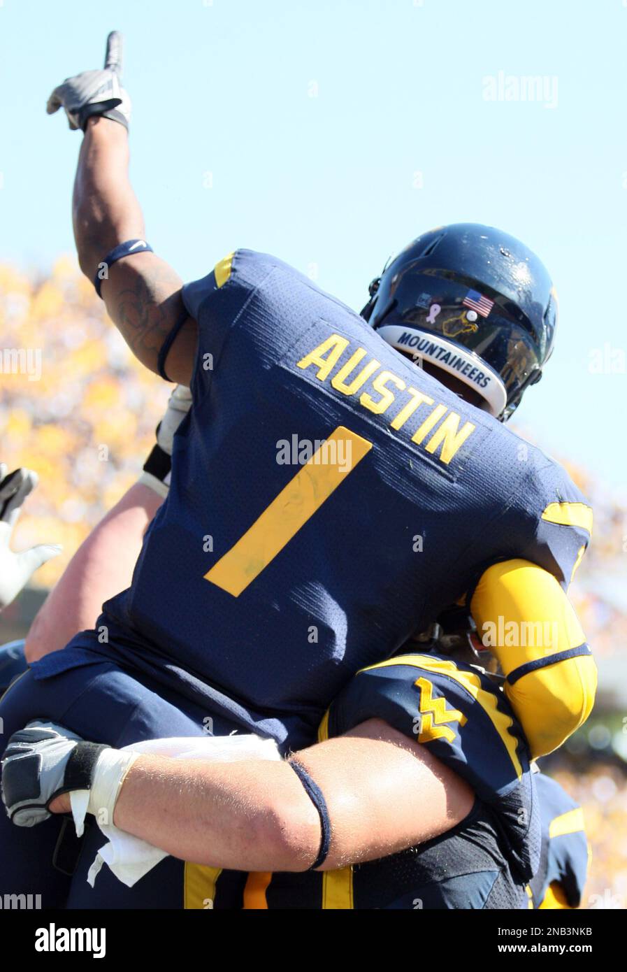West Virginia's Tavon Austin (1) celebrates a touchdown reception ...