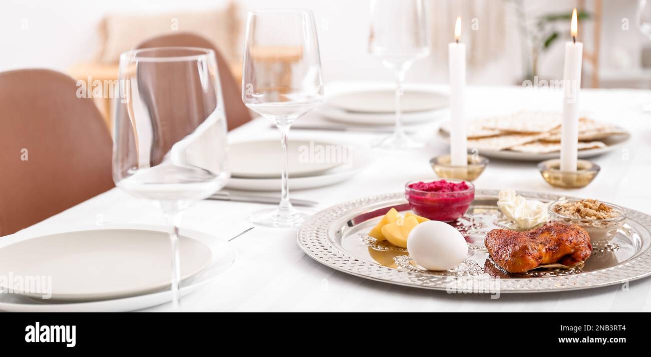 Passover Seder plate with traditional food on served table in dining ...