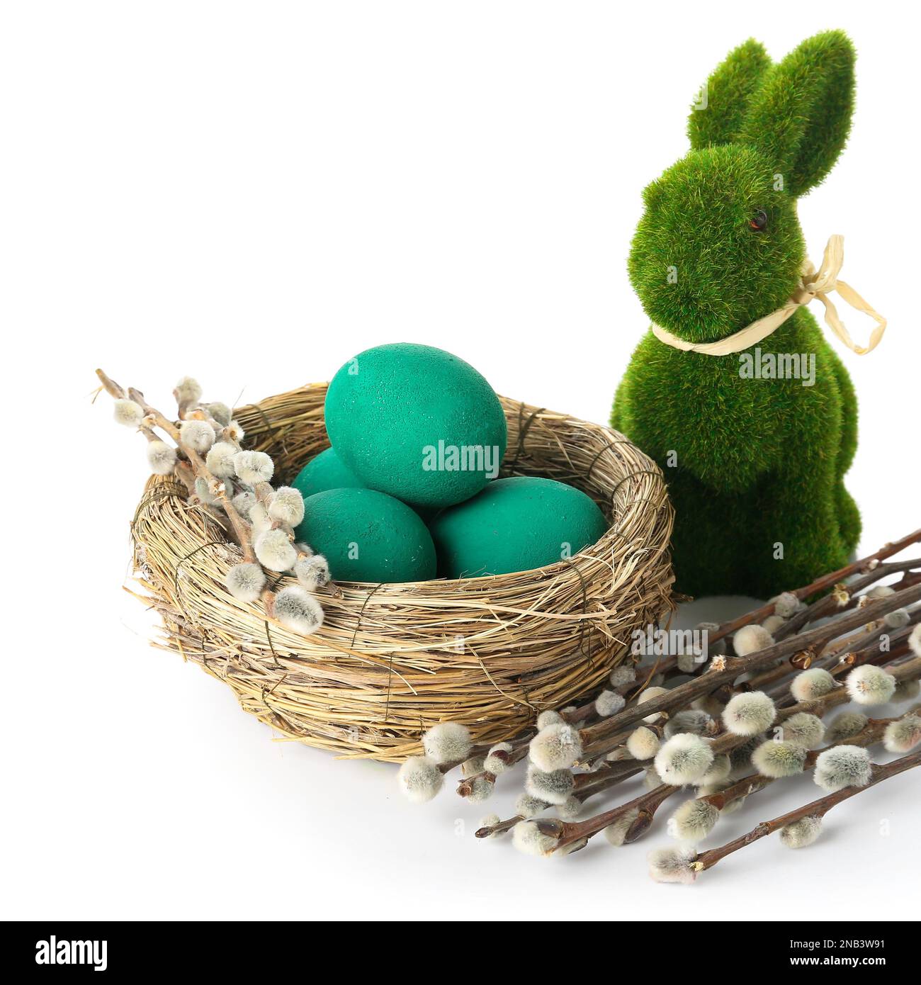 Nest with Easter eggs, rabbit and willow branches on white background ...