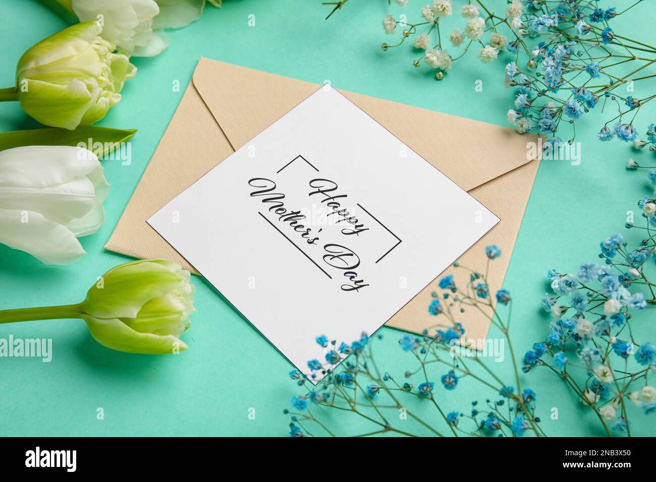 Composition with greeting card and beautiful flowers for Mother's day