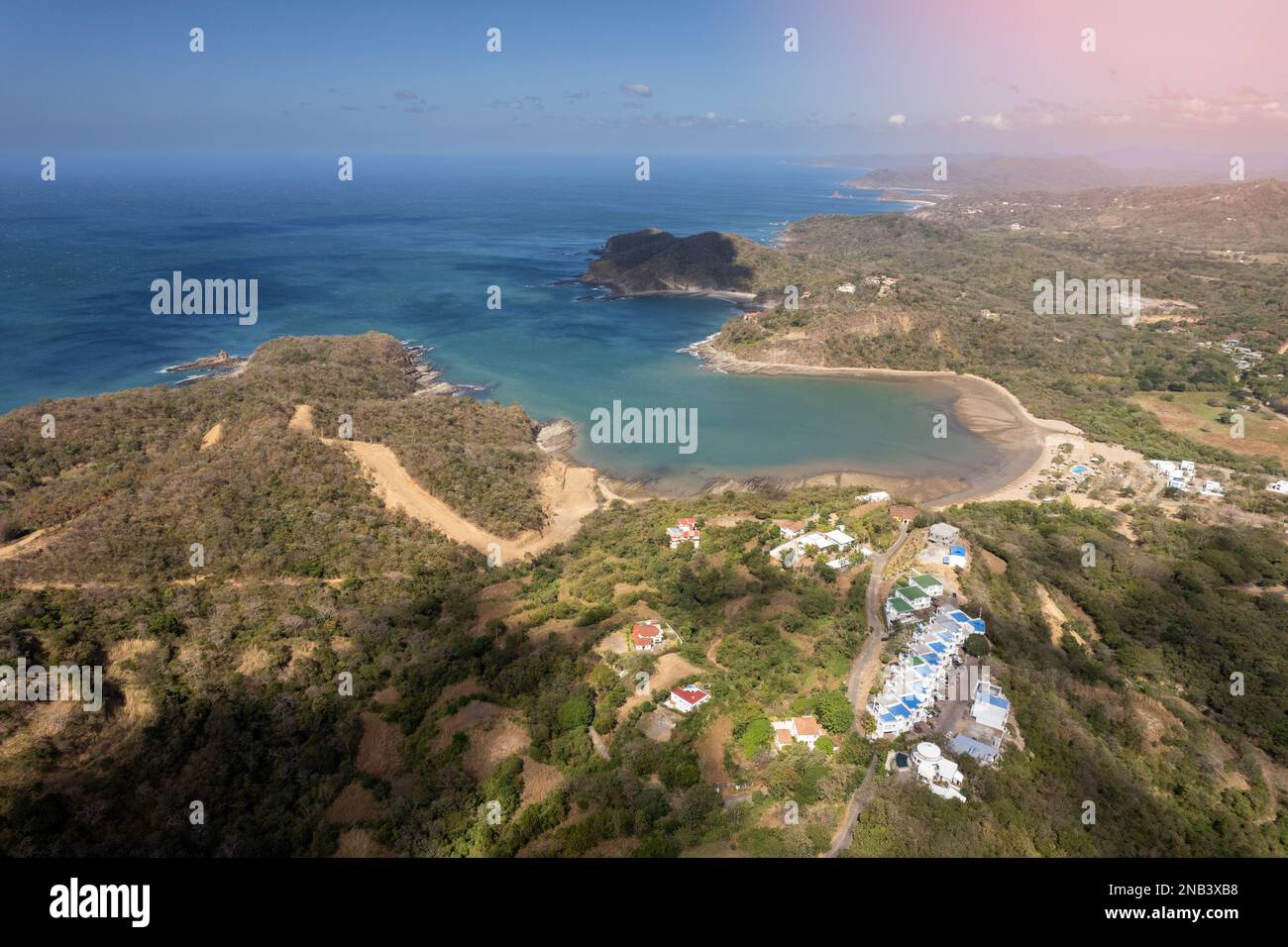 Rocky coastline in pacific ocean aerial drone view on bright sunny day Stock Photo