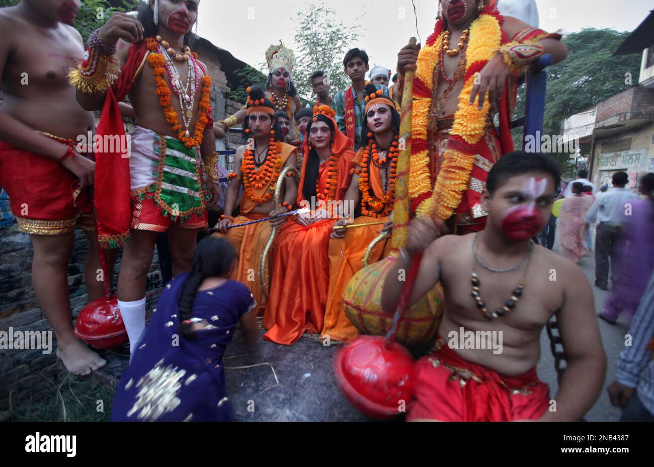 An Indian Hindu woman, in purple dress, touches the feet of artists ...