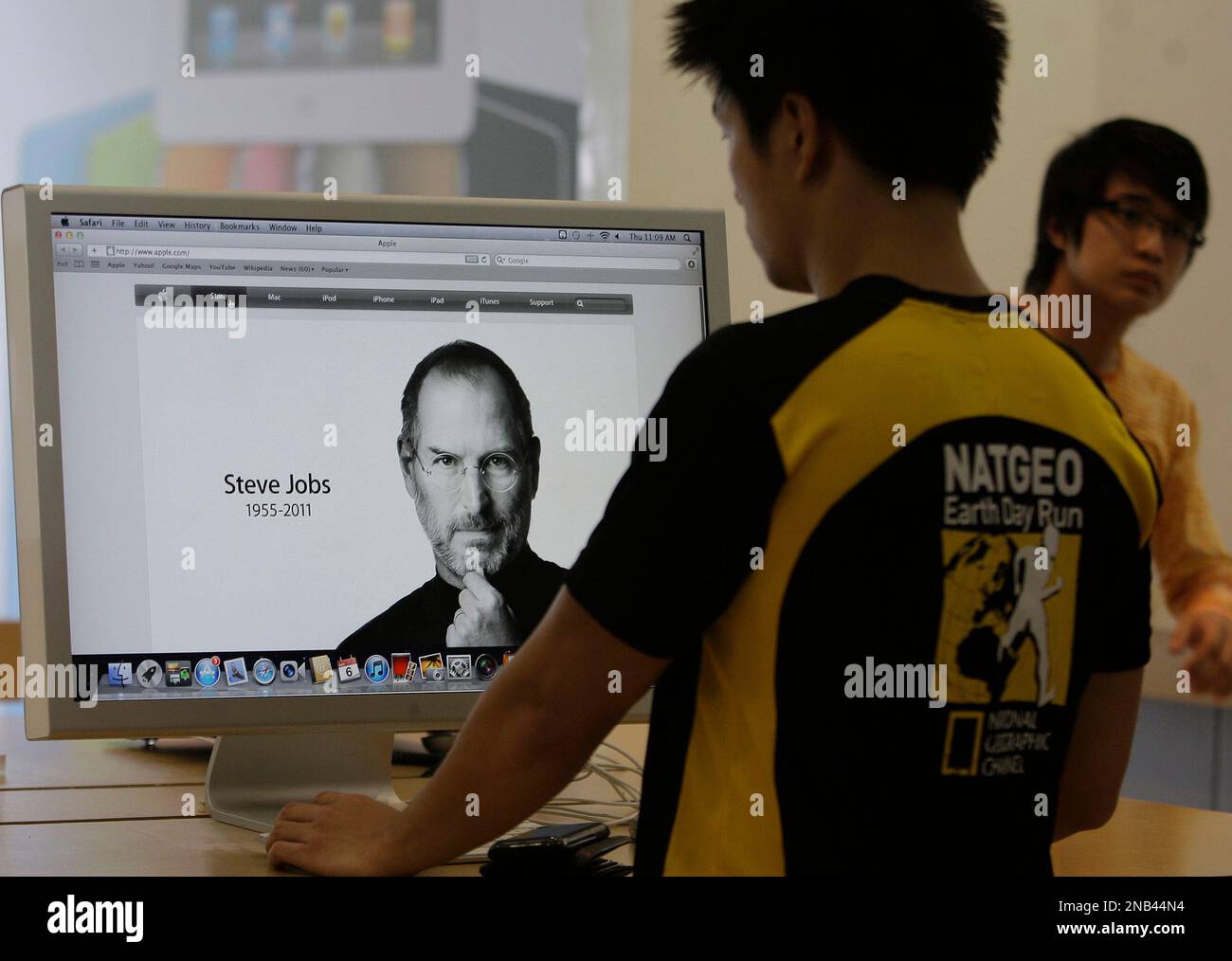 A Filipino man checks a computer showing a picture of Apple co-founder ...