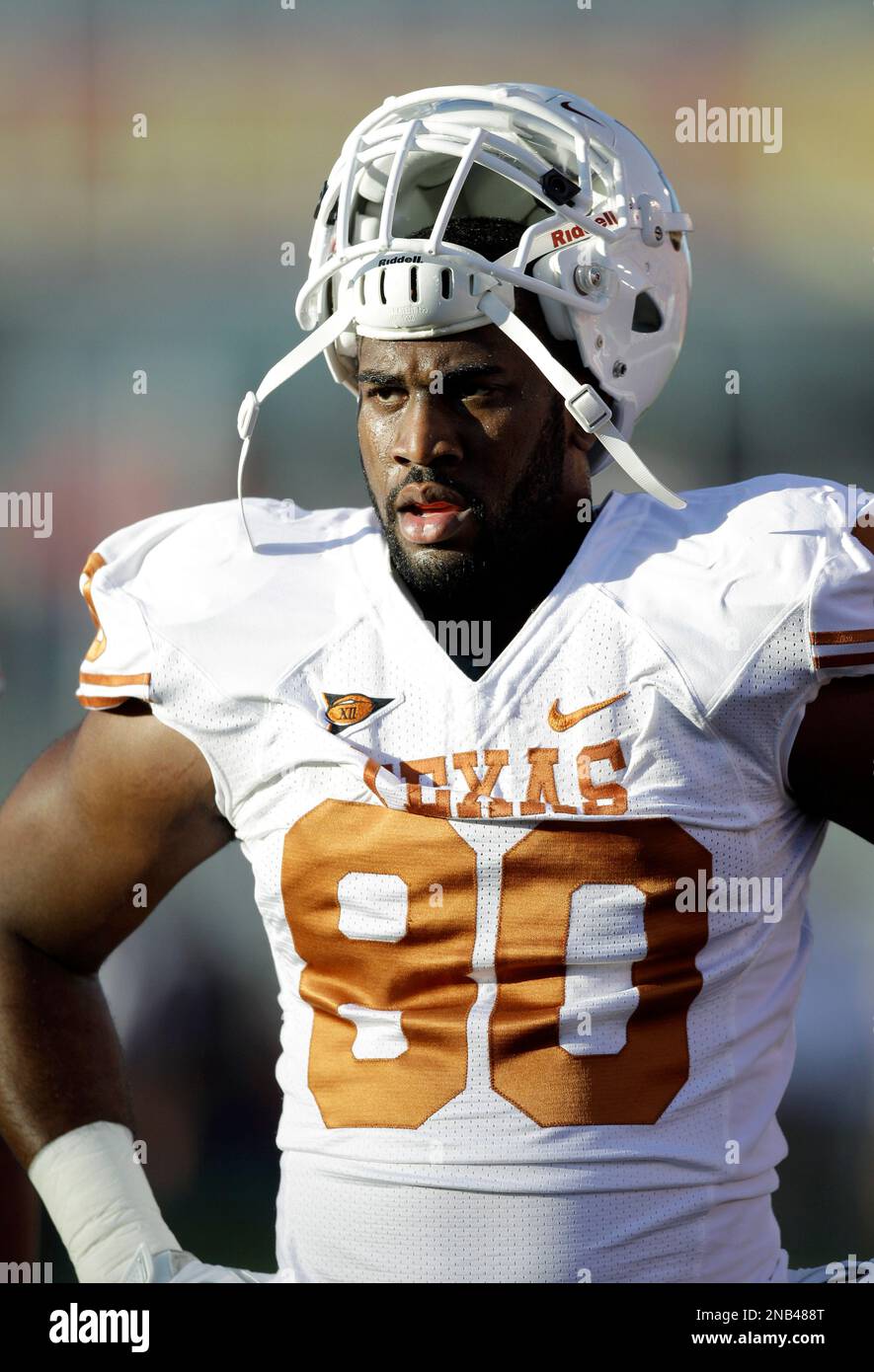 Texas defensive end Alex Okafor stands on the field before an NCAA