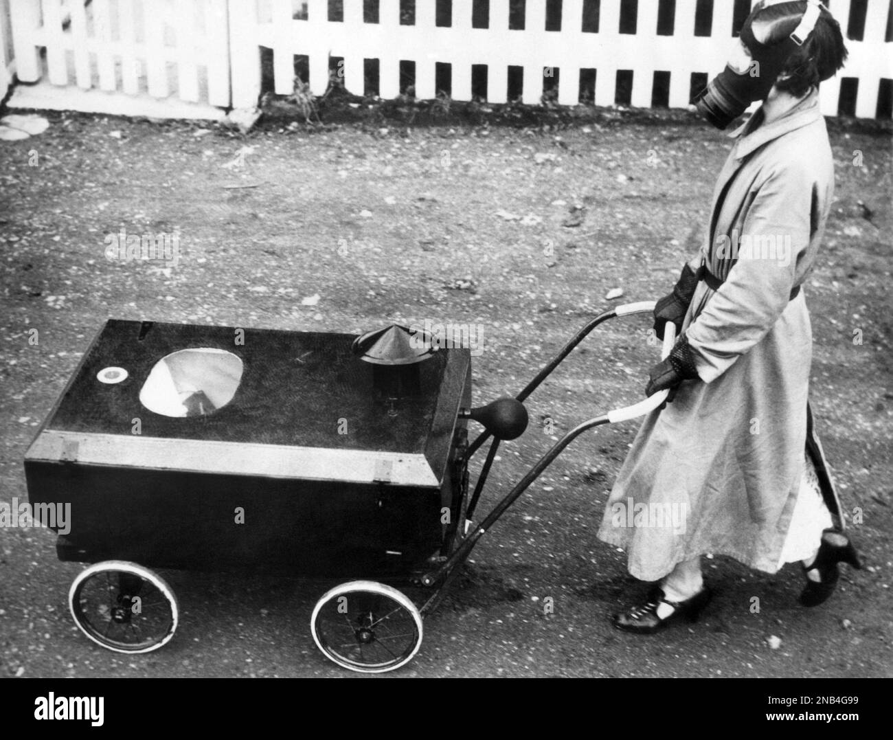 This gasmasked nurse is pushing a baby carriage, although it looks