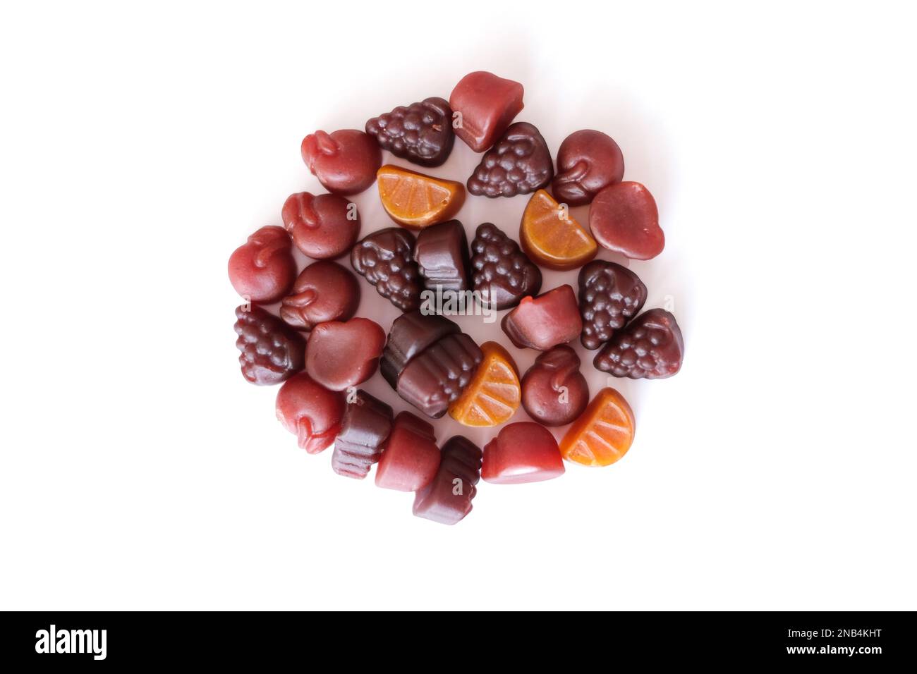 Close-up texture of yellow and brown multivitamin tablets in form of fruits on white background Stock Photo
