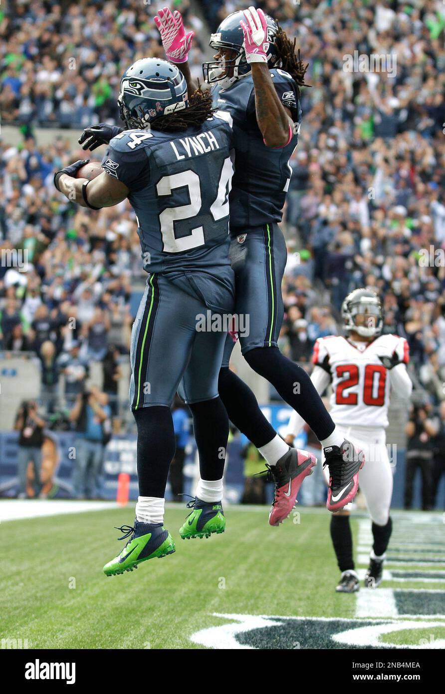 Seattle Seahawks Marshawn Lynch celebrates his touchdown against the  Atlanta Falcons by chest bumping teammate Sidney Rice in the second half of  a NFL football game, Sunday, Oct. 2, 2011, in Seattle. (, image size:892x1390