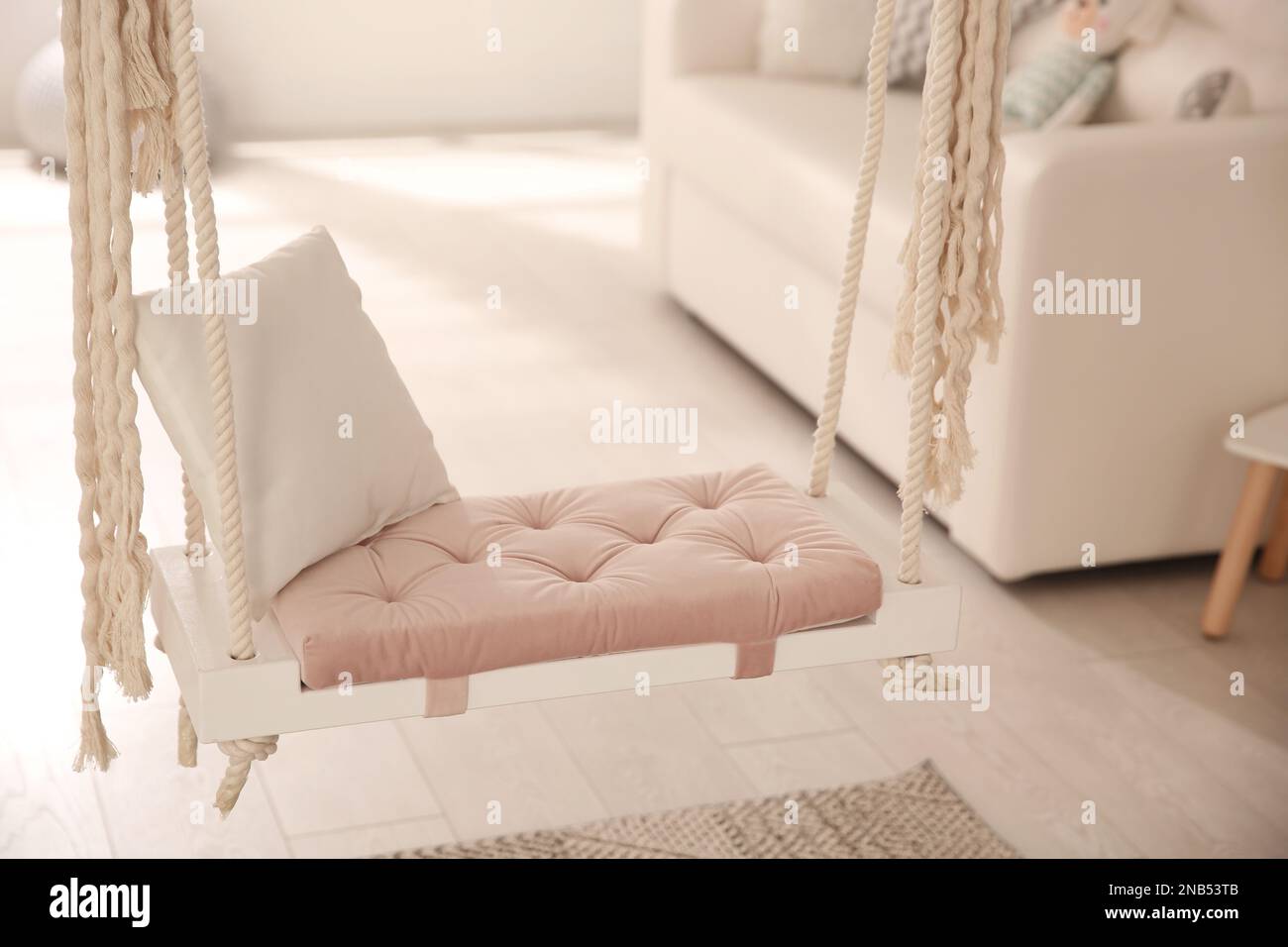 Beautiful swing with pillow in living room. Stylish interior design ...