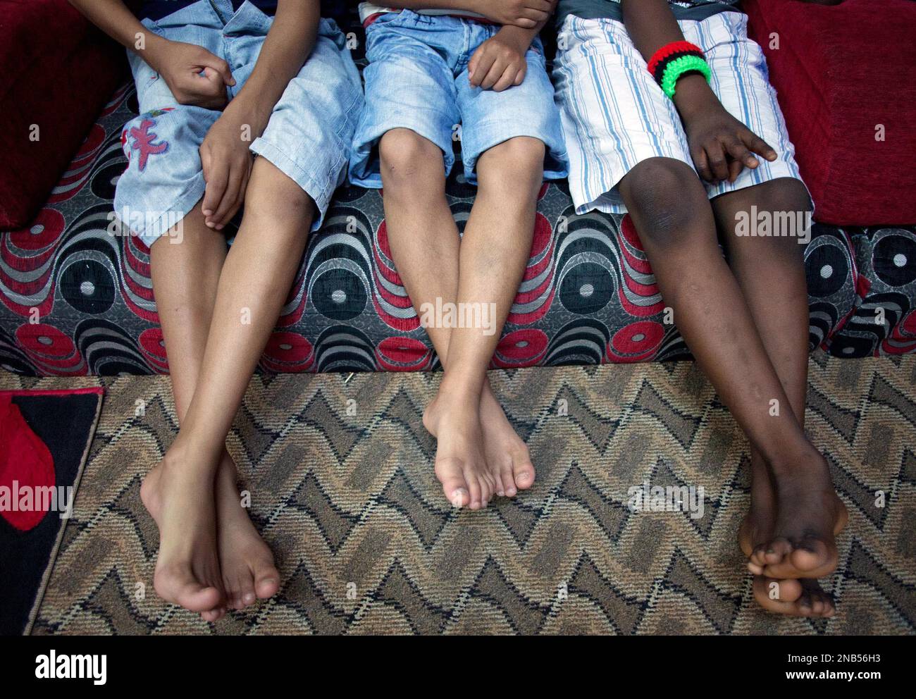 Boys watch television before dinner at an orphanage in Misrata, Libya,  Thursday, Sept. 29, 2011. (AP Photo/Manu Brabo Stock Photo - Alamy
