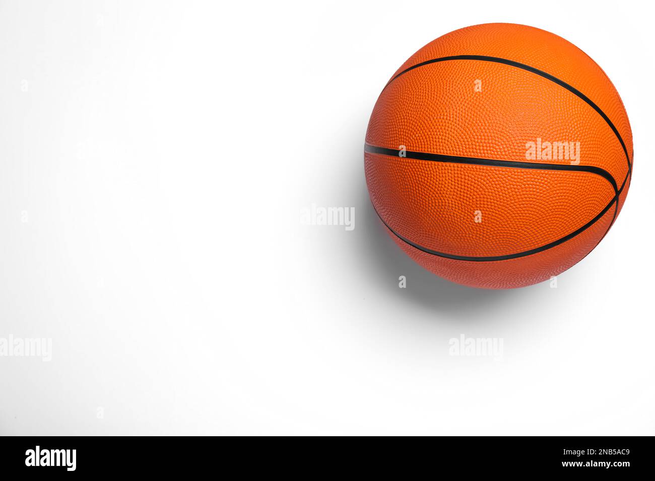 Orange ball on white background, top view. Basketball equipment Stock