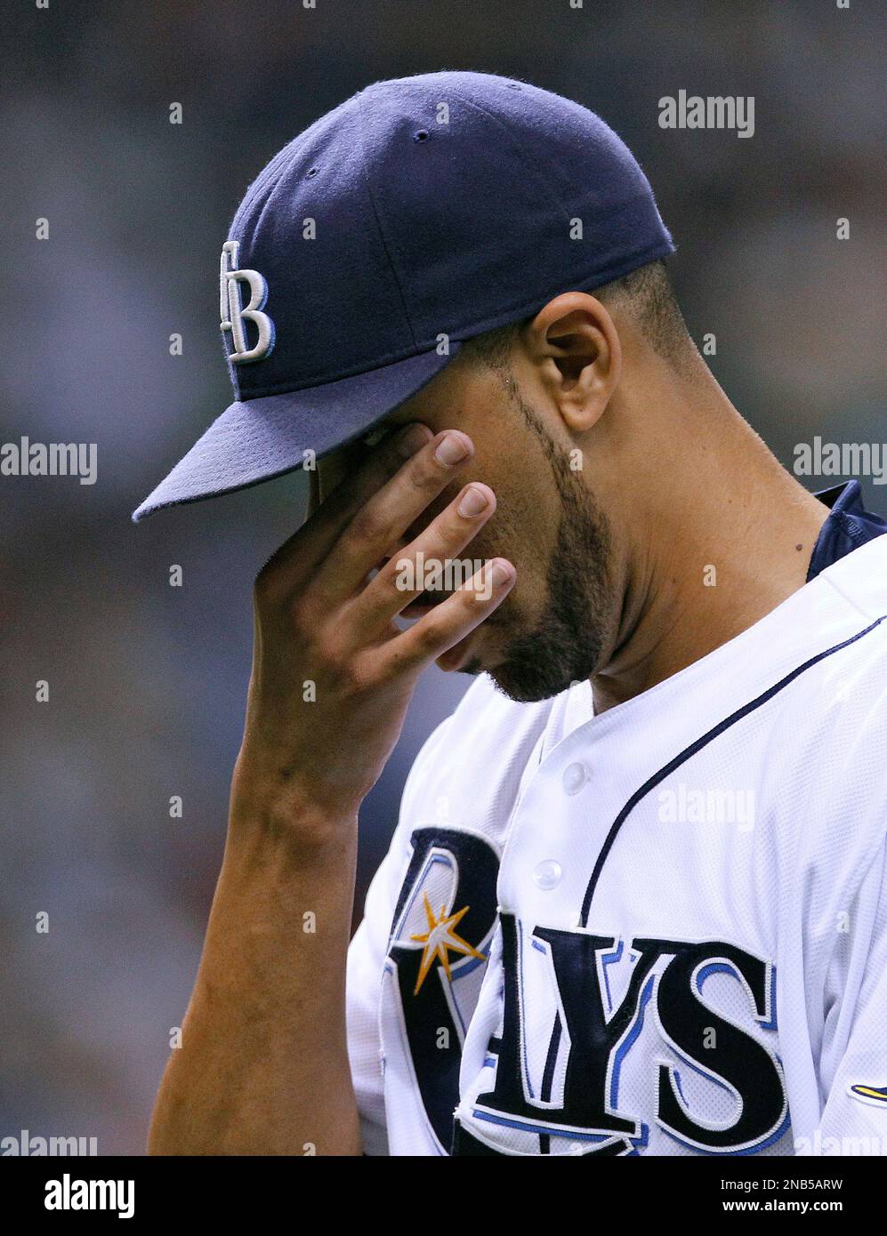 Tampa Bay Rays starting pitcher David Price wipes his eyes after