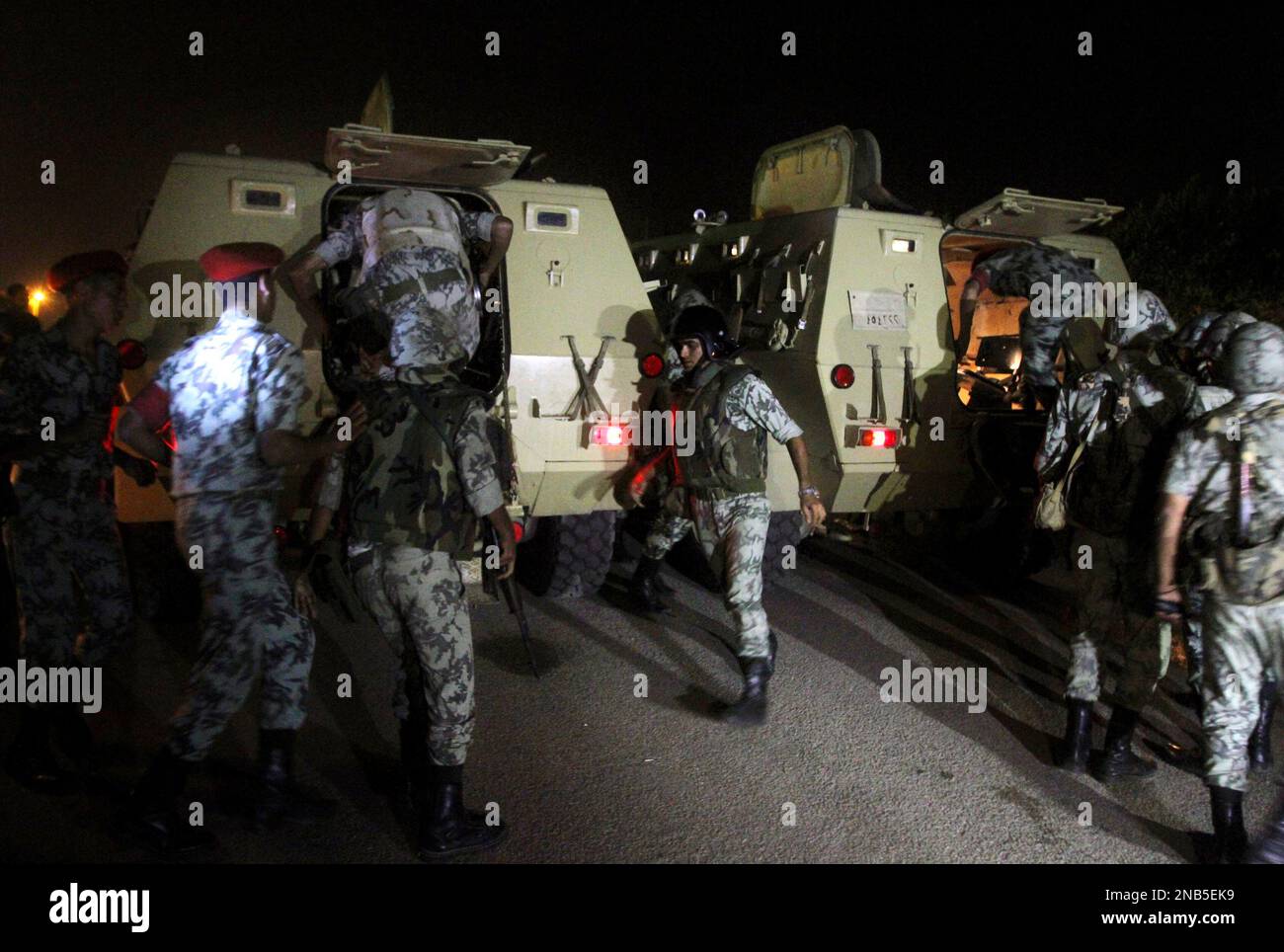 Egyptian army soldiers are loaded into their armored personal carriers