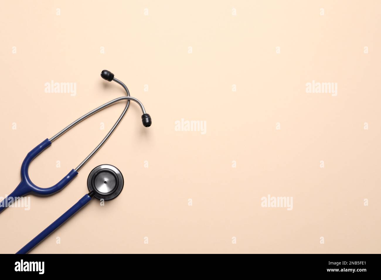 Stethoscope on beige background, top view. Space for text Stock Photo ...