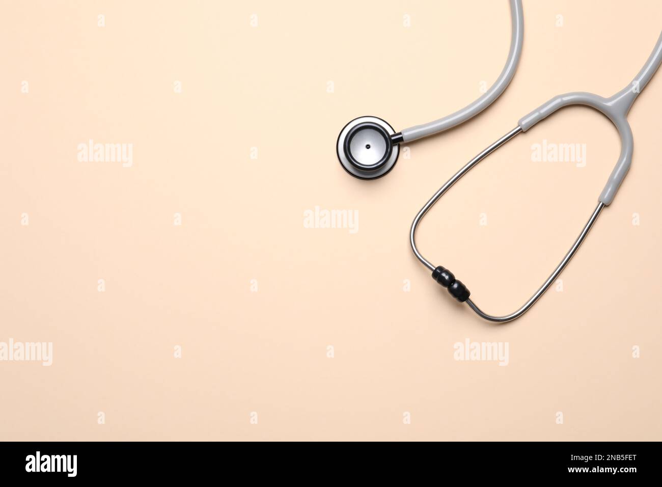 Stethoscope on beige background, top view. Space for text Stock Photo ...