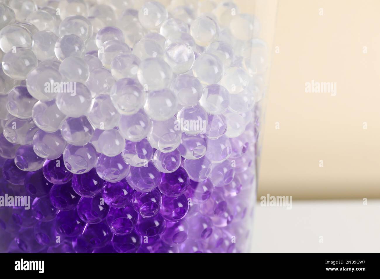 Different color fillers in glass vase, closeup. Water beads Stock Photo