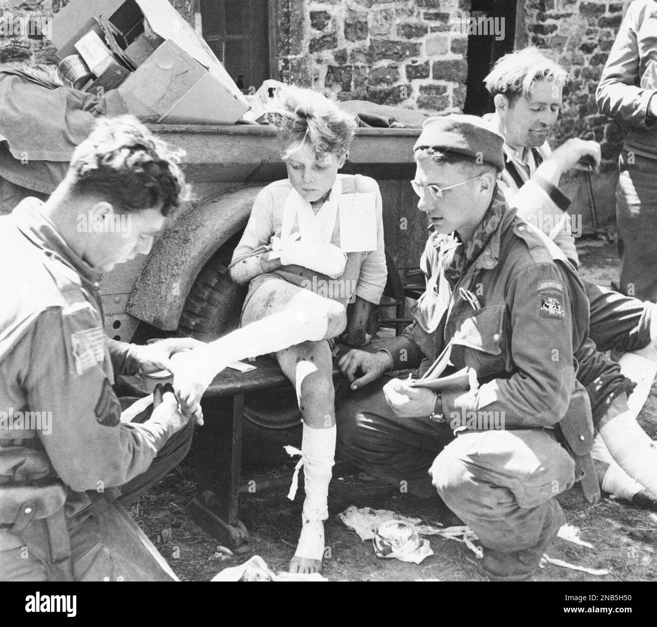 Wounded in both legs and his right arm by a German grenade during ...