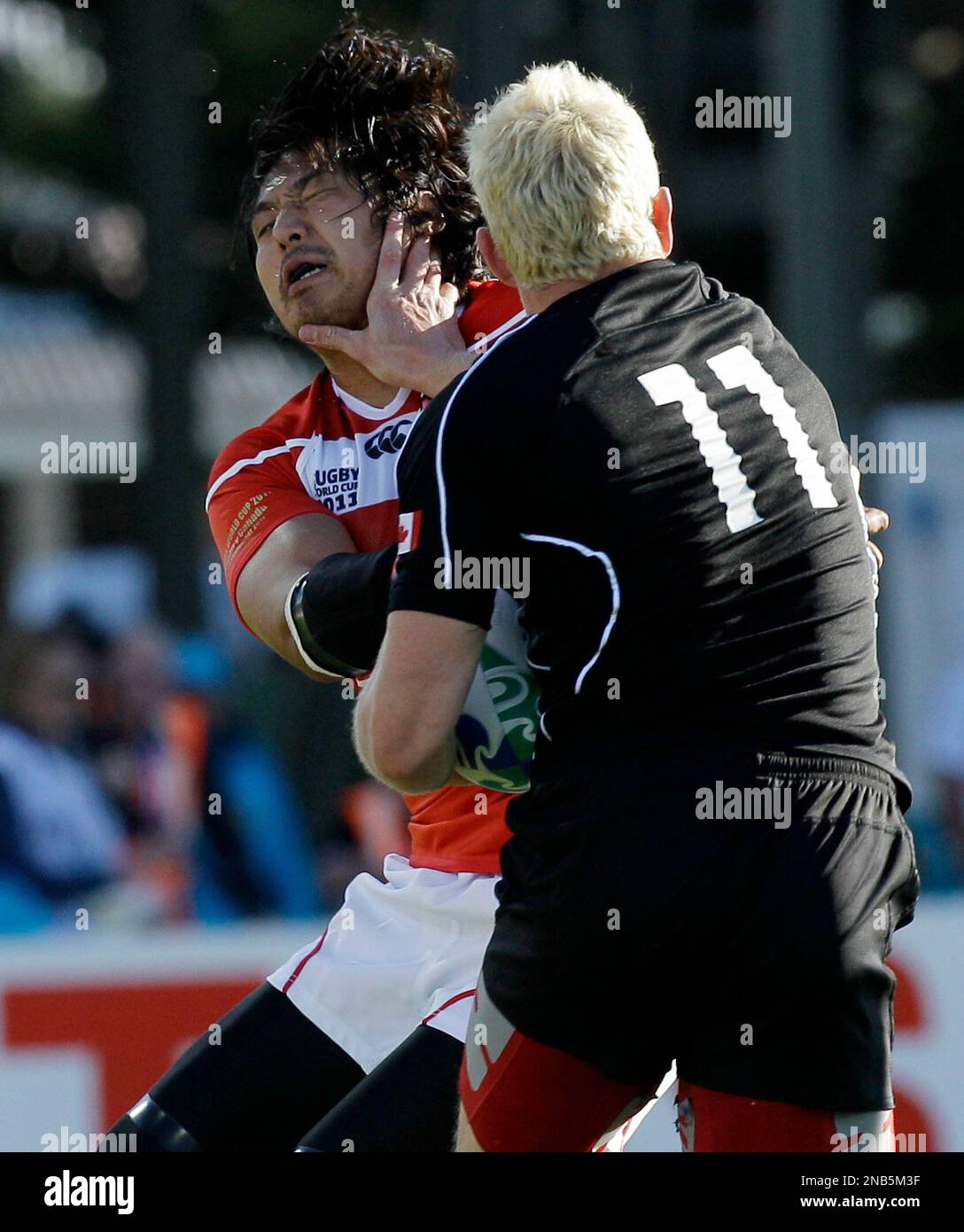 Japan's Kosuke Endo, left, is pushed away by Canada's Phil Mackenzie