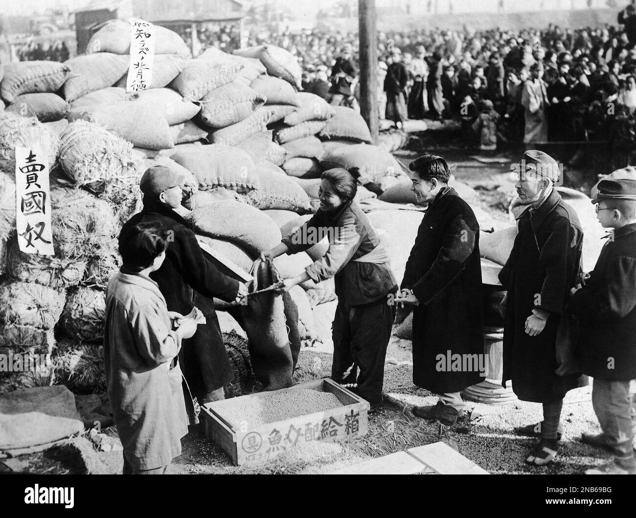 Japanese people receive soy beans from the Japanese army arsenal, Feb